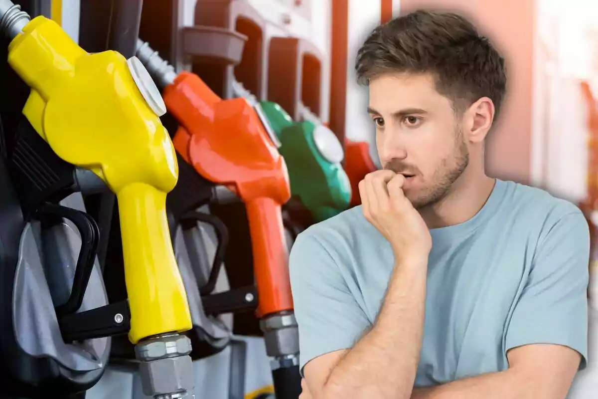 Thoughtful man in front of gas pumps of different colors