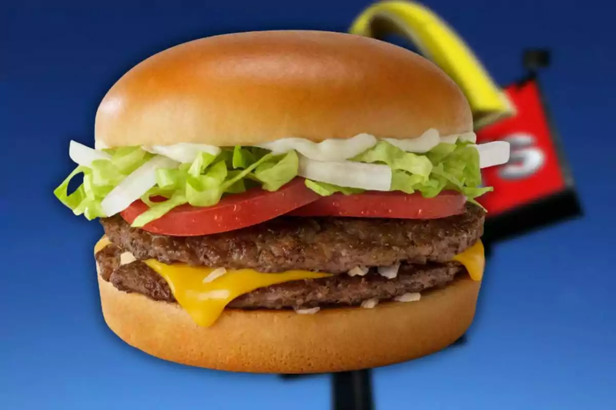 Daily Double burger with cheese, lettuce, tomato, and onion on a blue background Daily Double burger with cheese, lettuce, tomato, and onion on a blue background