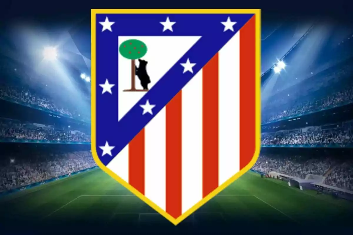 Escudo del Atlético de Madrid sobre un estadio de fútbol iluminado y lleno de espectadores