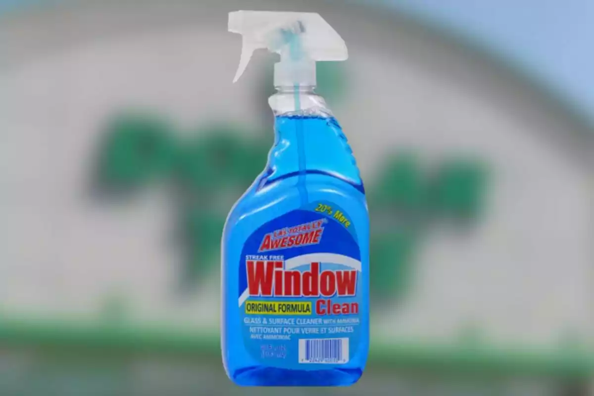 Blue window cleaner bottle with sprayer and red and yellow label Blue window cleaner bottle with sprayer and red and yellow label