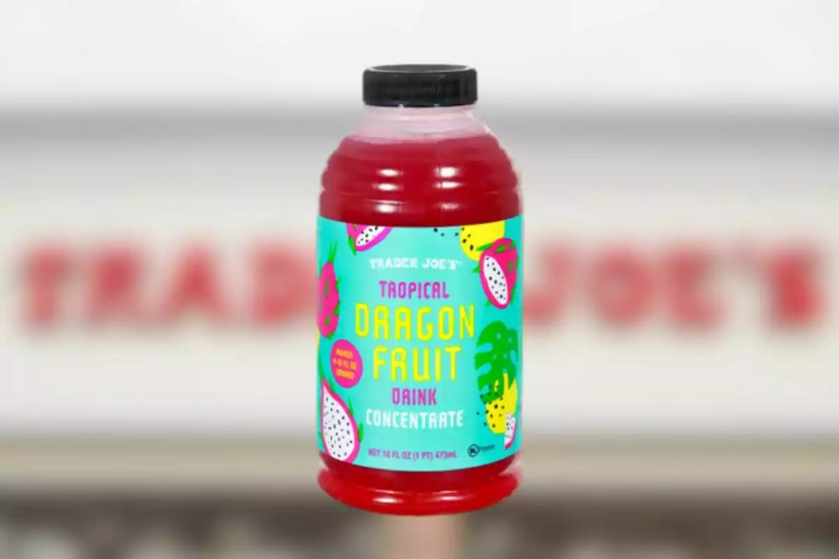 Trader Joe’s tropical dragon fruit beverage concentrate bottle with colorful label against a blurred background Trader Joe’s tropical dragon fruit beverage concentrate bottle with colorful label against a blurred background