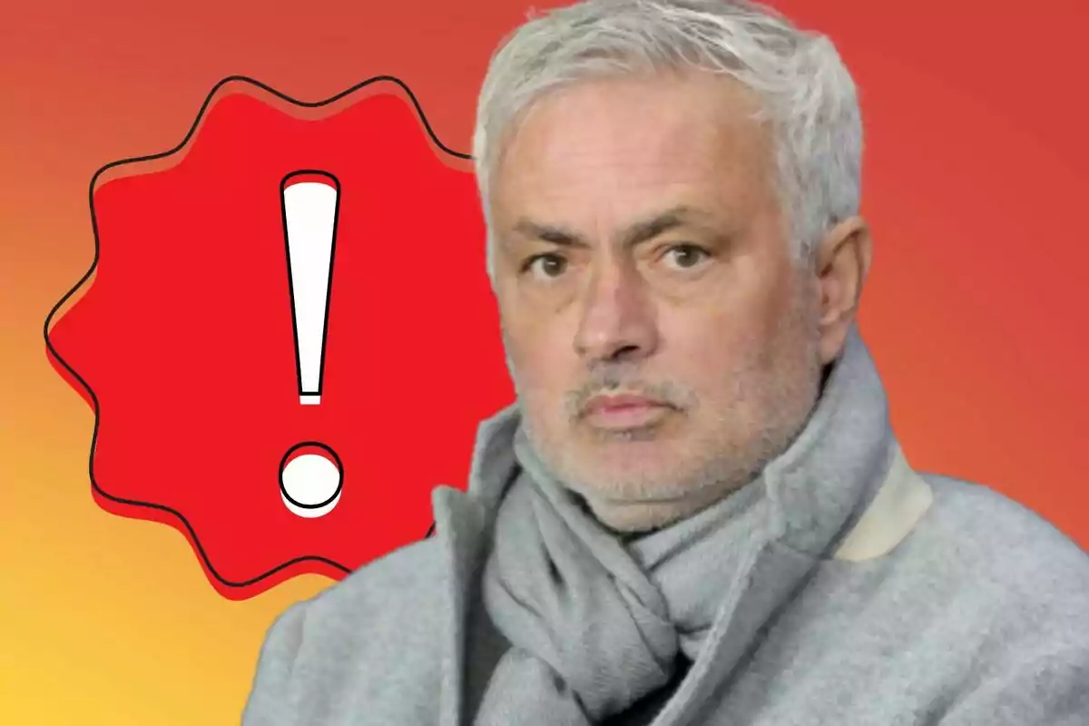Hombre de cabello canoso con bufanda gris y expresión seria frente a un fondo rojo con un símbolo de advertencia