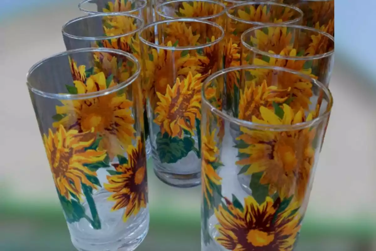 Decorated glass cups with yellow sunflowers and green leaves Decorated glass cups with yellow sunflowers and green leaves