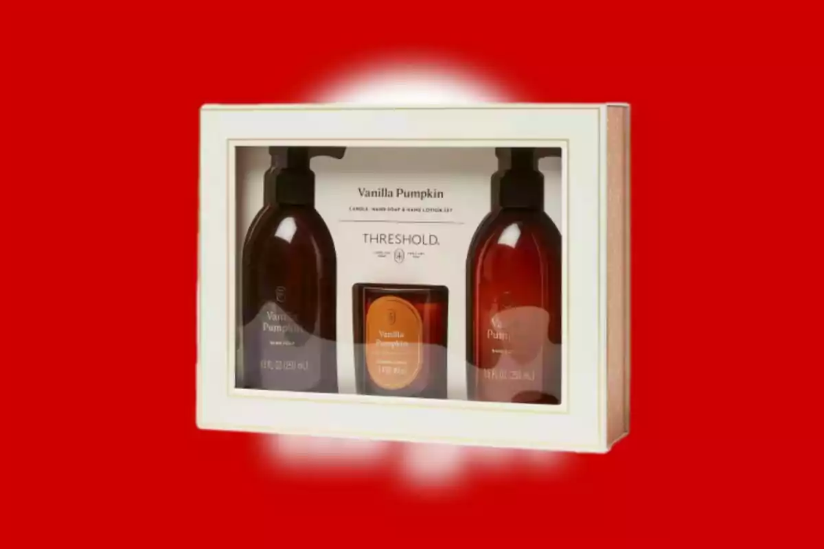 Gift set with hand soap, lotion, and vanilla pumpkin scented candle in a white box on a red background Gift set with hand soap, lotion, and vanilla pumpkin scented candle in a white box on a red background