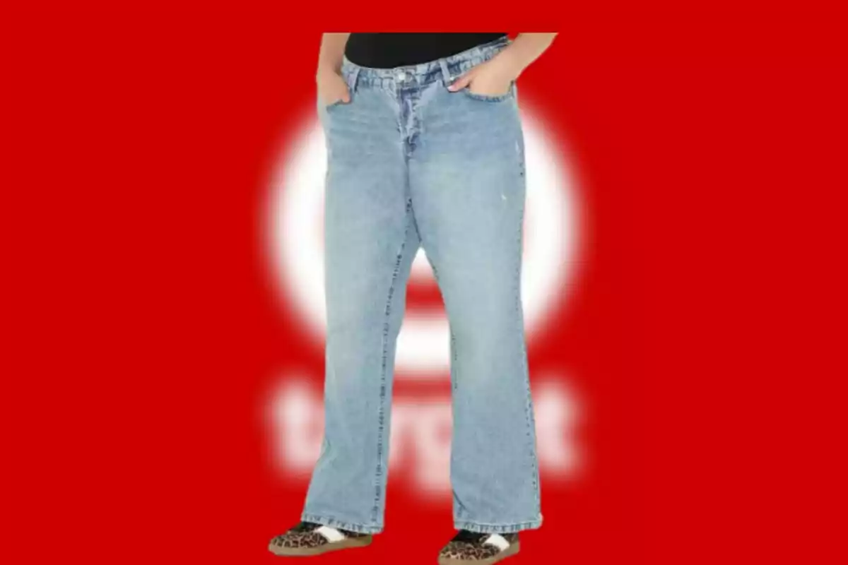 Person wearing light denim jeans and animal print slippers on a red background with a blurred white circle. Person wearing light denim jeans and animal print slippers on a red background with a blurred white circle.