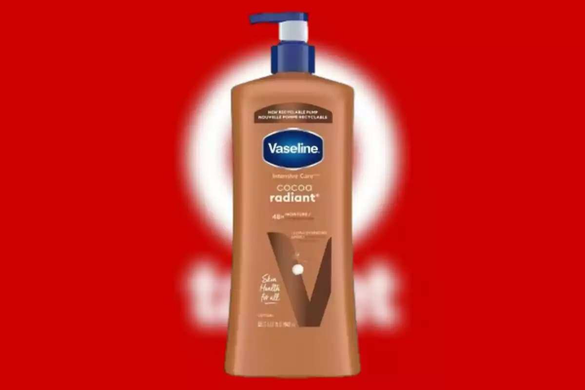 Vaseline Cocoa Radiant lotion bottle with blue dispenser on a red background Vaseline Cocoa Radiant lotion bottle with blue dispenser on a red background
