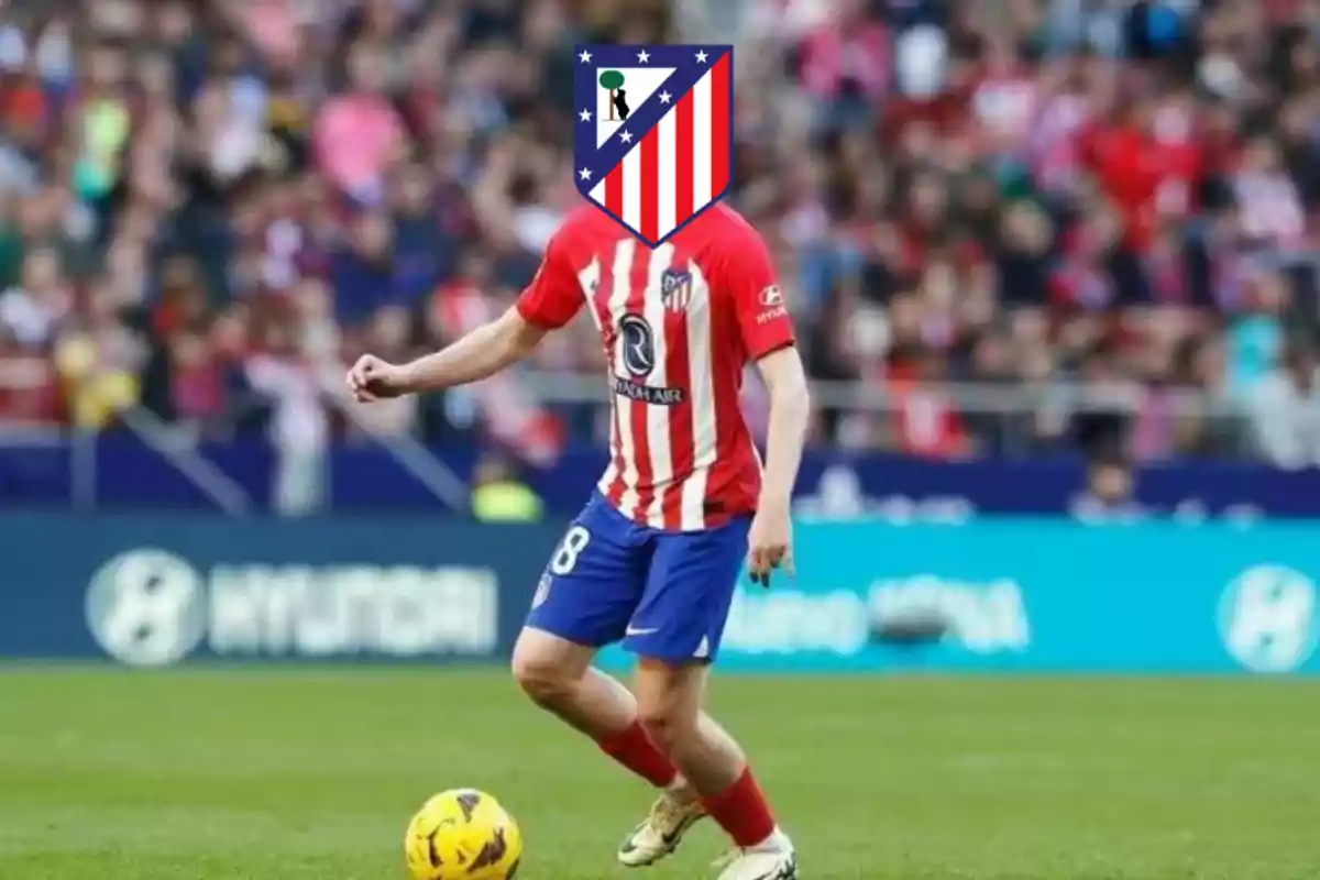 Un jugador de fútbol con el uniforme del Atlético de Madrid en el campo de juego, con el escudo del equipo en lugar de su rostro.