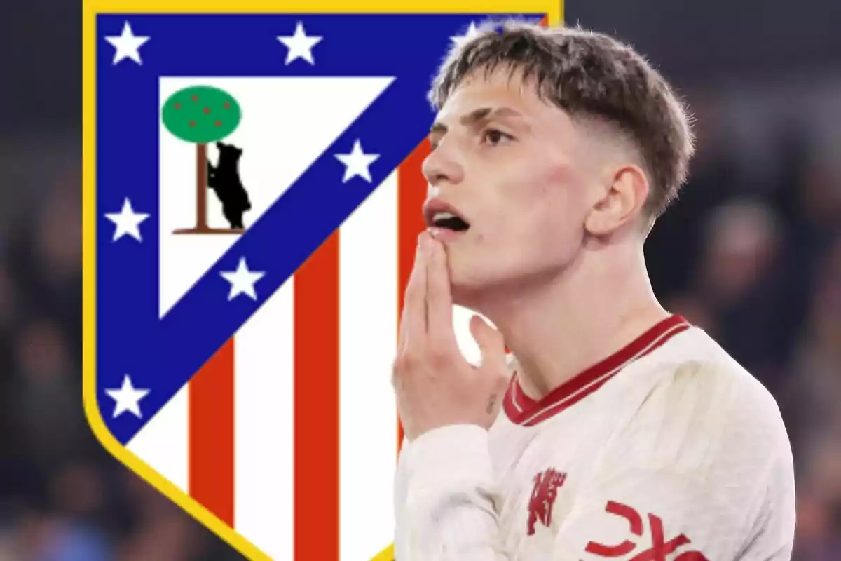 Un jugador de fútbol con expresión pensativa está frente al escudo del Atlético de Madrid.