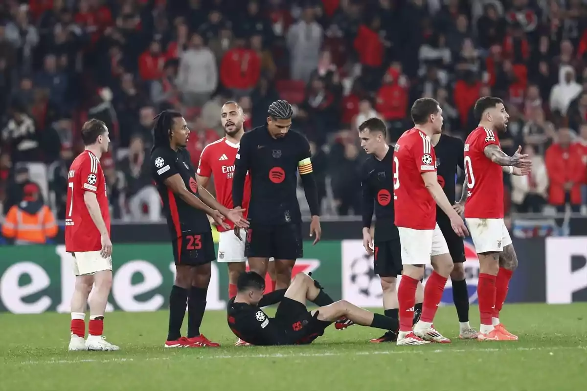 Imagen de un partido de fútbol entre dos equipos, uno vestido de negro y otro de rojo, mientras protestan al árbitro Imagen de un partido de fútbol entre dos equipos, uno vestido de negro y otro de rojo, mientras protestan al árbitro