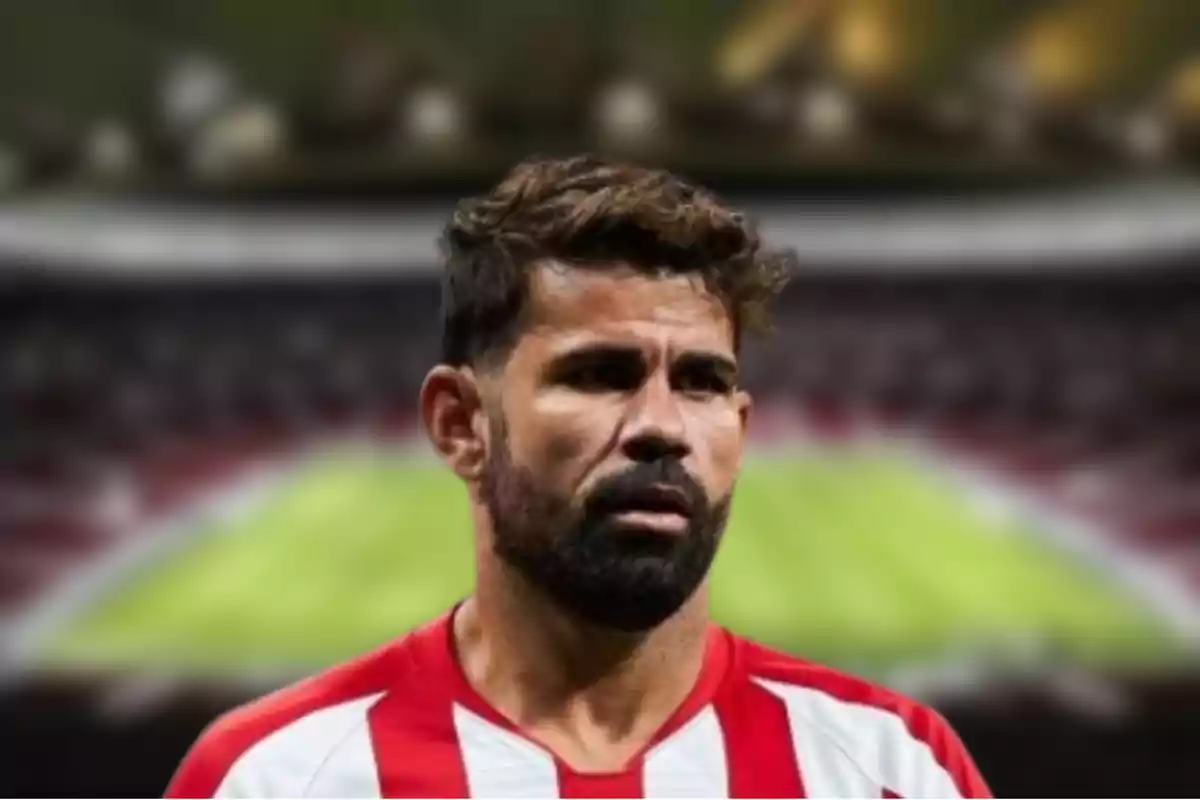 Un jugador de fútbol con uniforme rojo y blanco en un estadio.