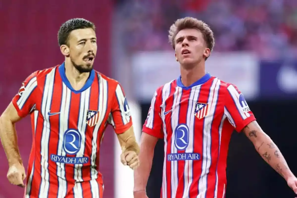 Dos jugadores de fútbol con uniforme del Atlético de Madrid en un campo.