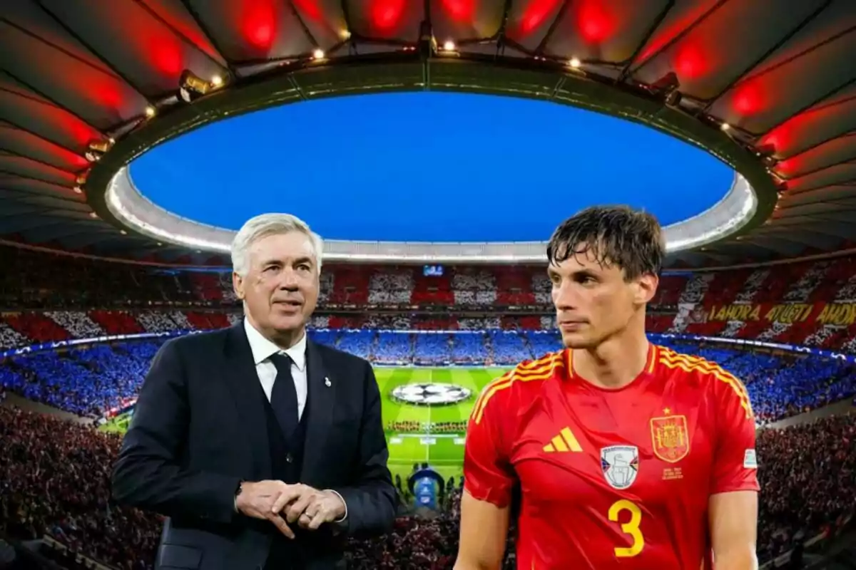 Un entrenador de fútbol y un jugador con uniforme rojo en un estadio lleno de aficionados.