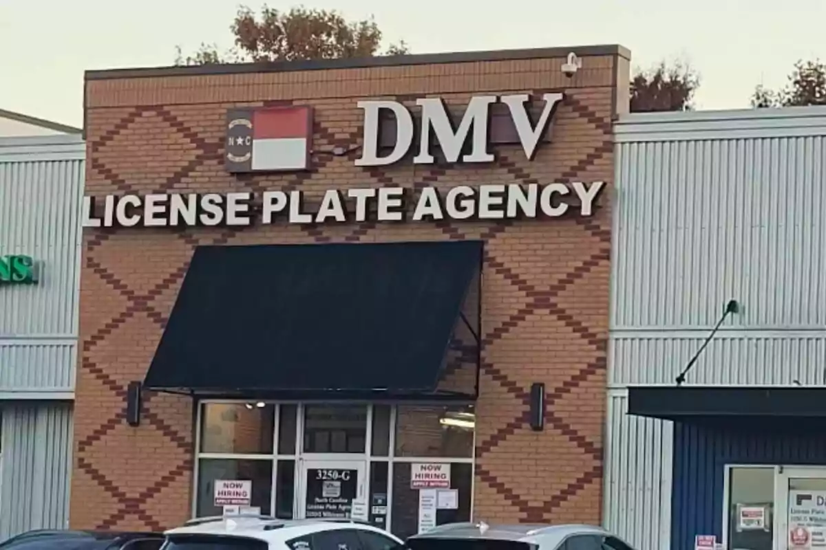 Facade of a DMV License Plate Agency office with a black awning and several cars parked in front Facade of a DMV License Plate Agency office with a black awning and several cars parked in front