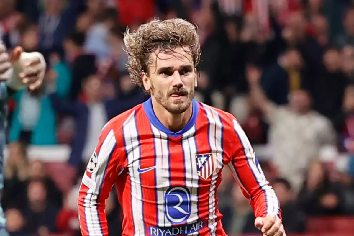 Soccer player in red and white uniform on the field during a match.