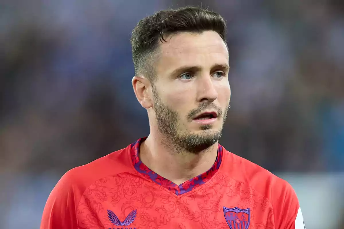 Un jugador de fútbol con camiseta roja del Sevilla FC en el campo.