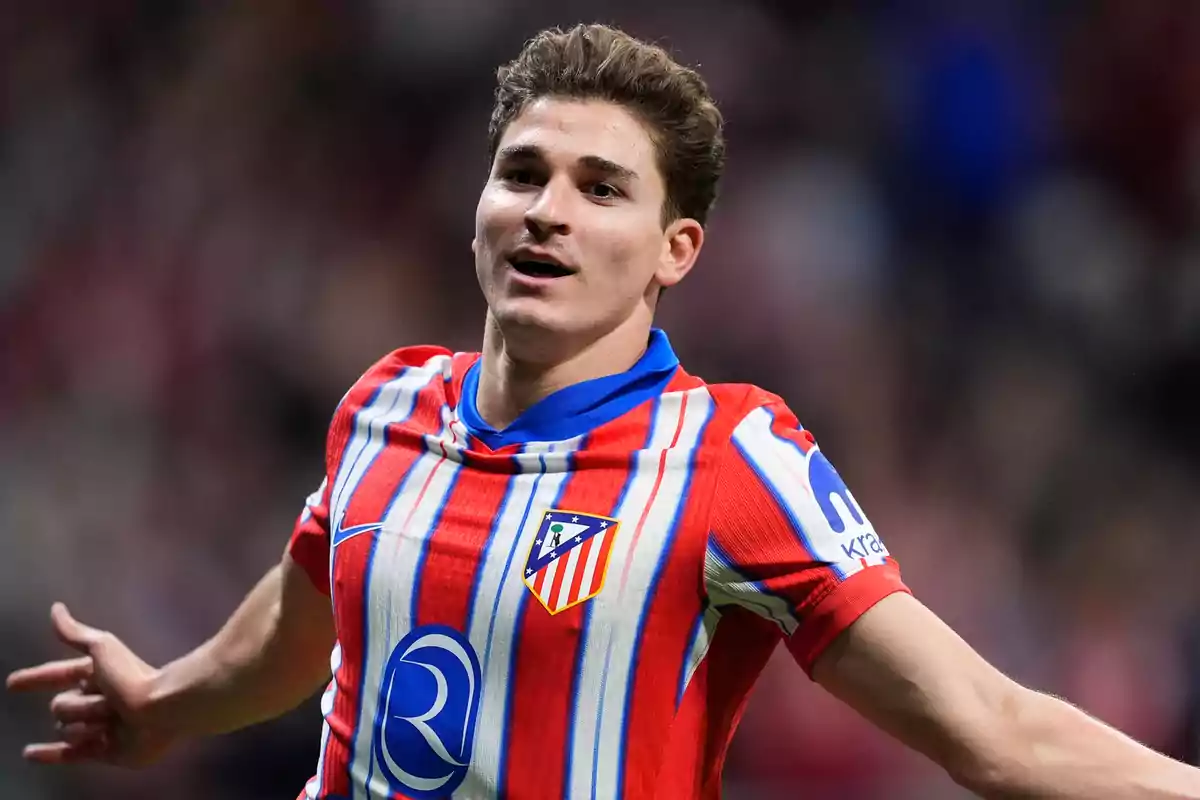 soccer player celebrating a goal with the Atlético de Madrid jersey.