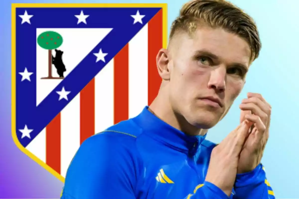 A player in a blue jacket is in front of the Atlético de Madrid crest.