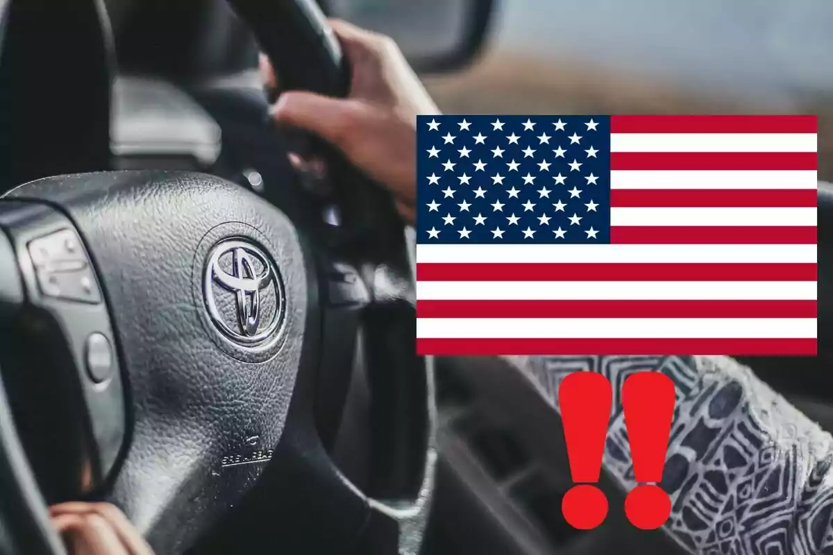Person driving a Toyota car with a United States flag and two overlapping red exclamation marks