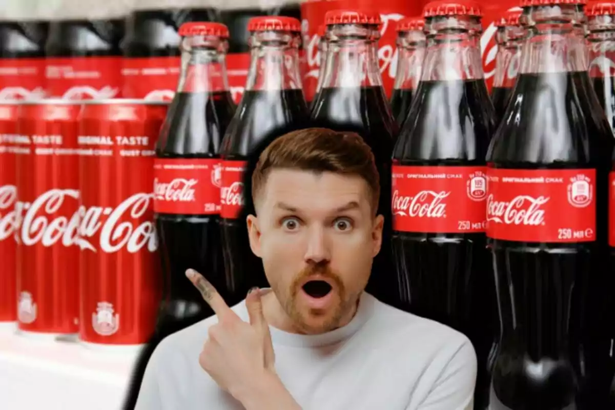 A surprised man points to a group of bottles and soda cans with red labels. A surprised man points to a group of bottles and soda cans with red labels.