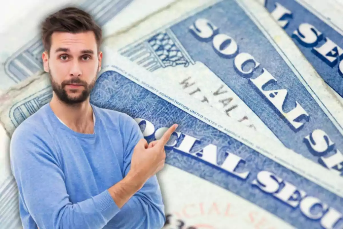 Man with a beard and blue sweater pointing toward several United States Social Security cards in the background Man with a beard and blue sweater pointing toward several United States Social Security cards in the background