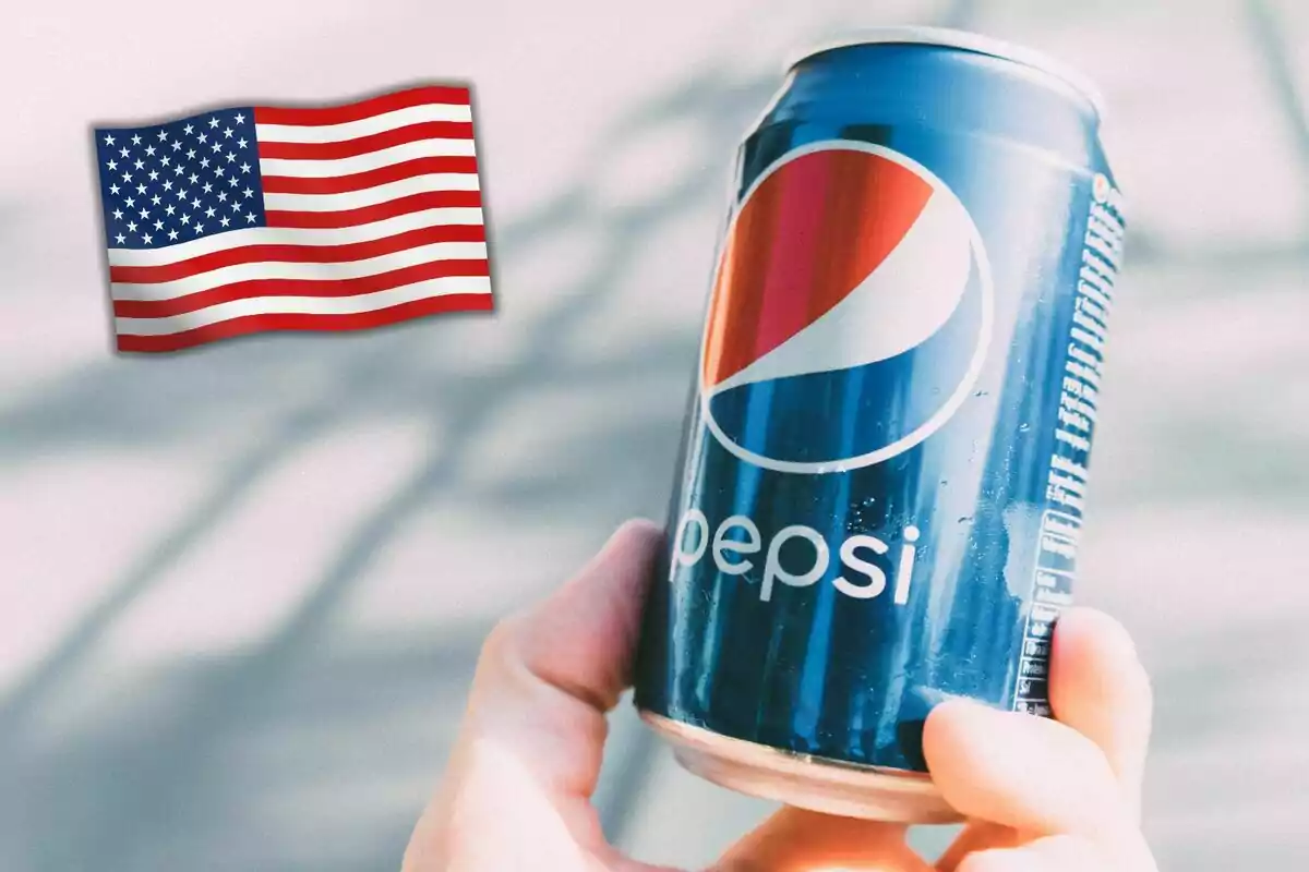 Person holding a can of Pepsi with an American flag in the background