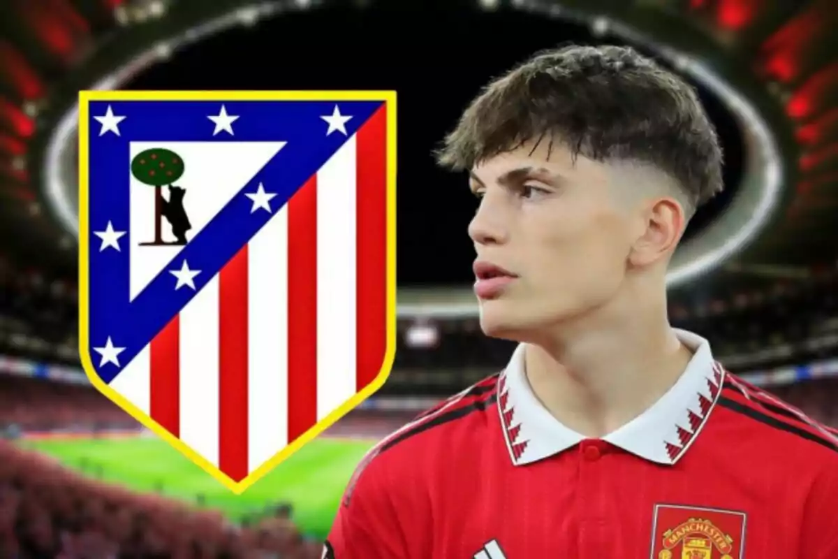 A football player wearing a Manchester United jersey stands next to the Atletico Madrid crest in a floodlit stadium.