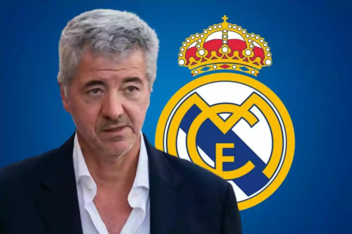 A gray-haired man with a stubbly beard and a serious expression is in front of the Real Madrid crest against a blue background.