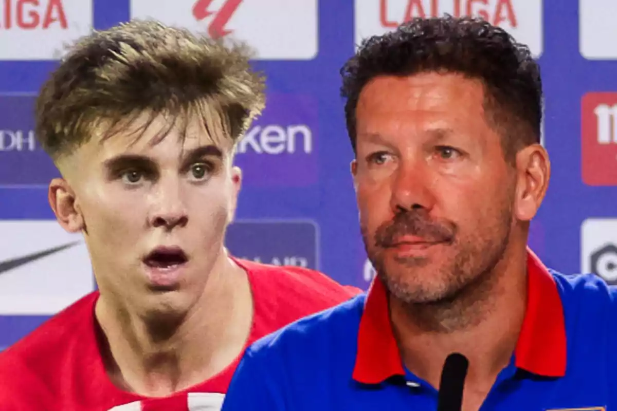 A young footballer in a red and white shirt stands next to a middle-aged man with a beard and a blue shirt at a press conference.