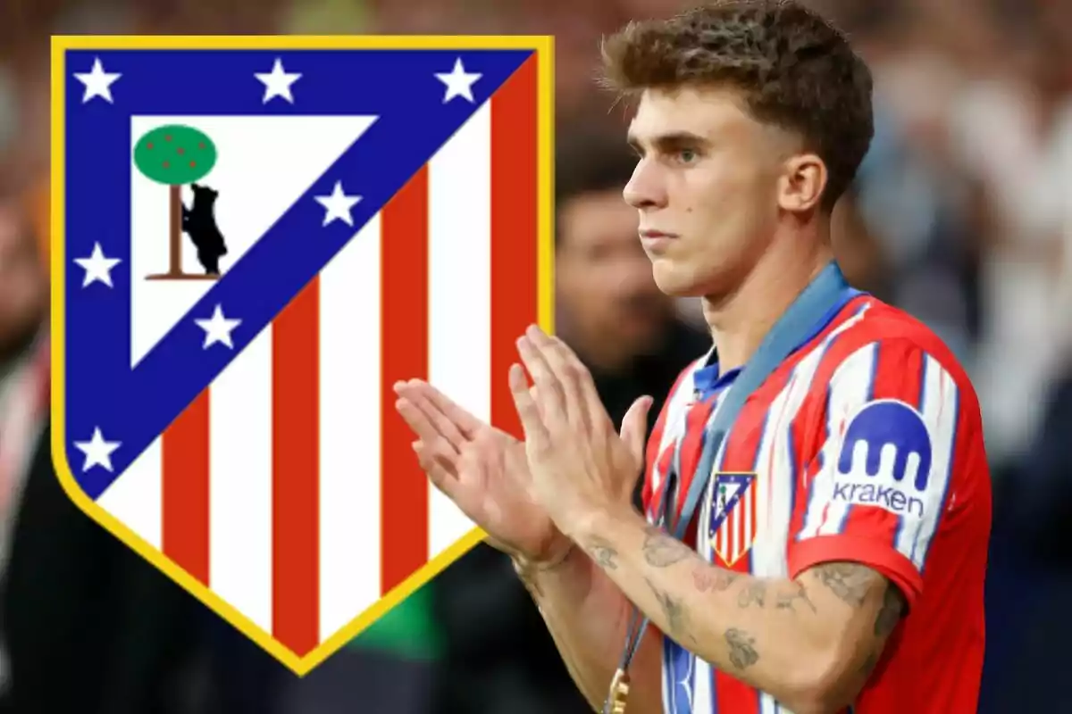 Jugador del Atlético de Madrid aplaudiendo con el escudo del equipo en el fondo.