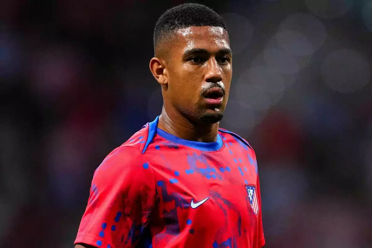 A football player in a red and blue Atlético de Madrid shirt on the pitch.