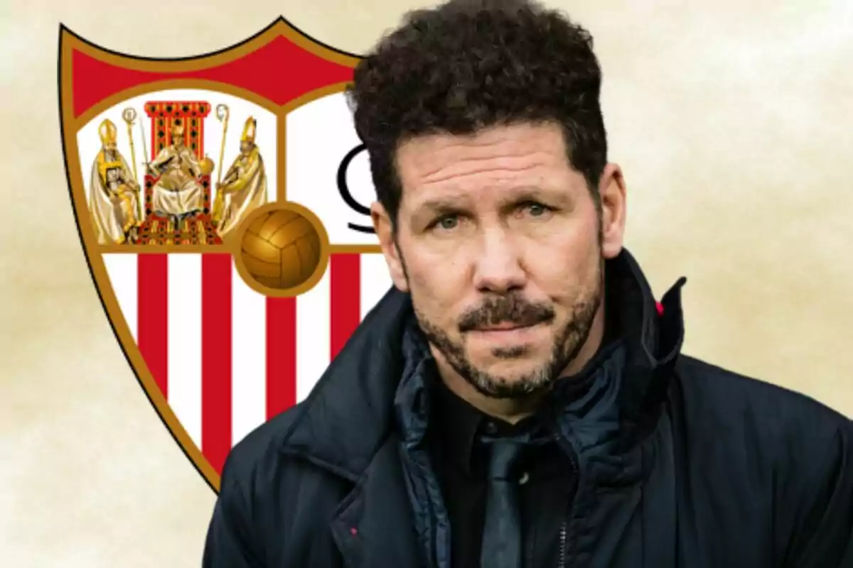 A man with a beard and curly hair is in front of a soccer team shield with a beige background.