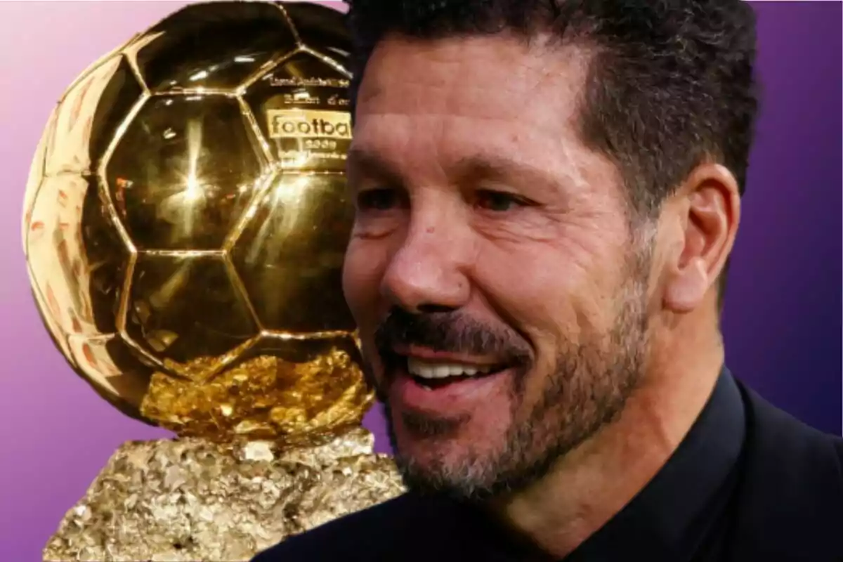 Un hombre sonriente con barba frente a un trofeo dorado sobre un fondo morado.